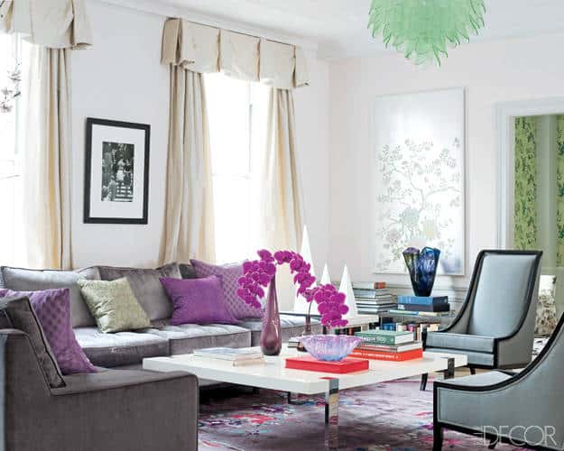 White walls with beautiful window treatments and traditional furnishing with lots of purple and green accents in a formal living room. 