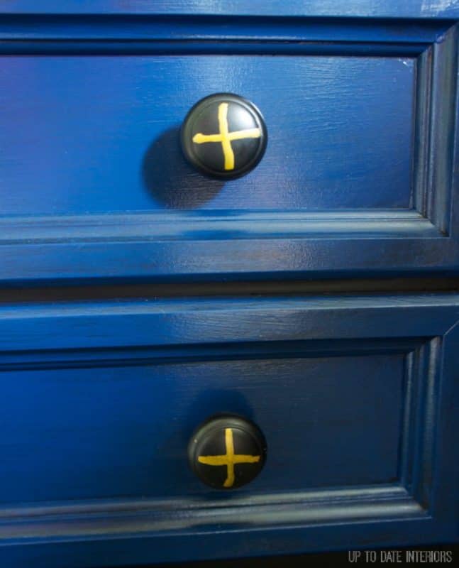 Dresser knobs for boys on a navy dresser.