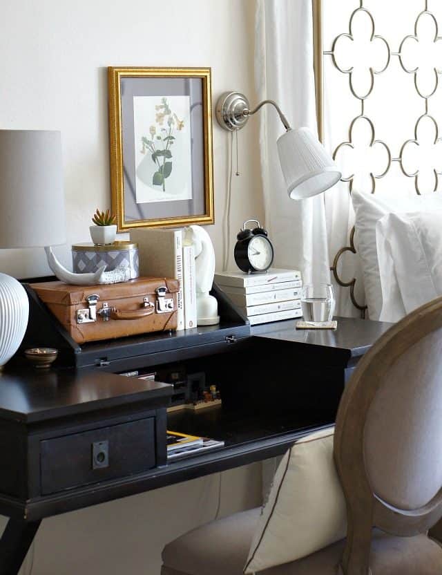 use a desk as a bedside table and renter friendly wall sconce in bedroom