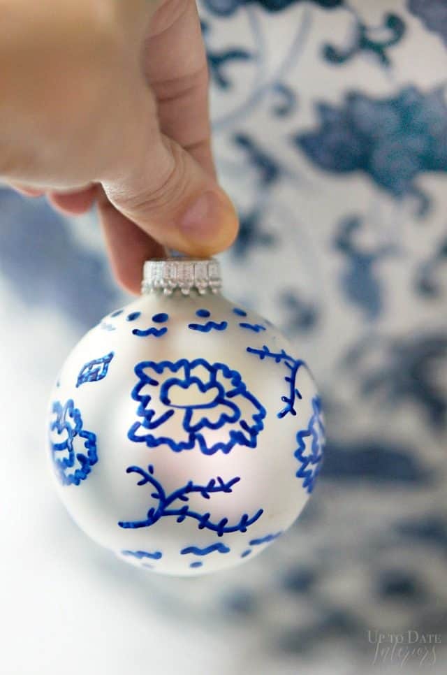 A close up of a hand painted DIY chinoiserie ornament. 