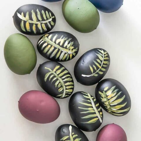 Diy Easter Eggs Botancial hand painted with moody colors and palm leaves.