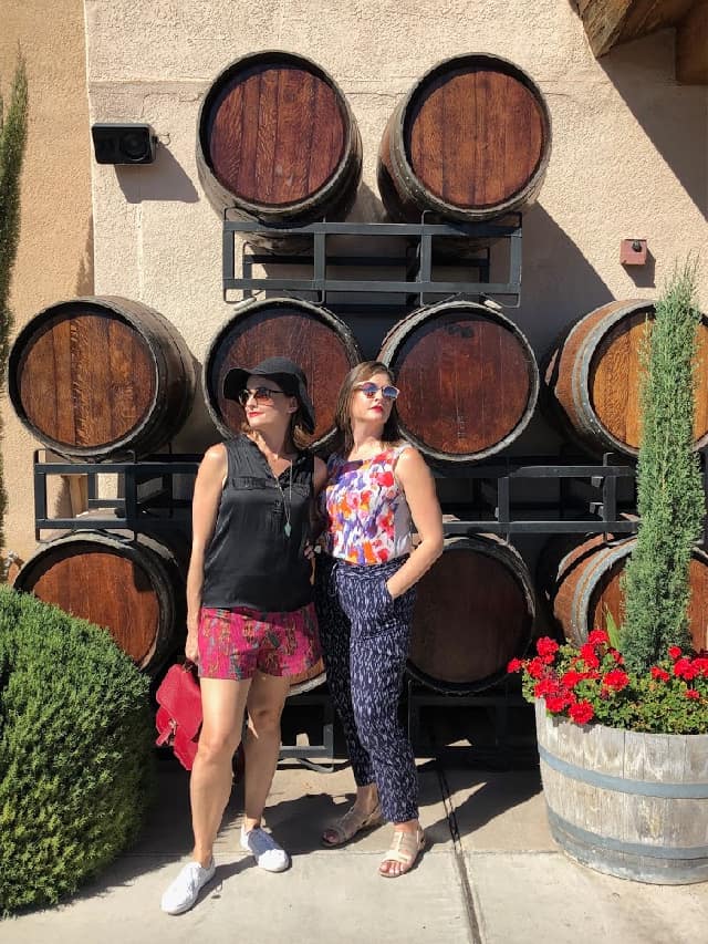Two girls in front of a winery.