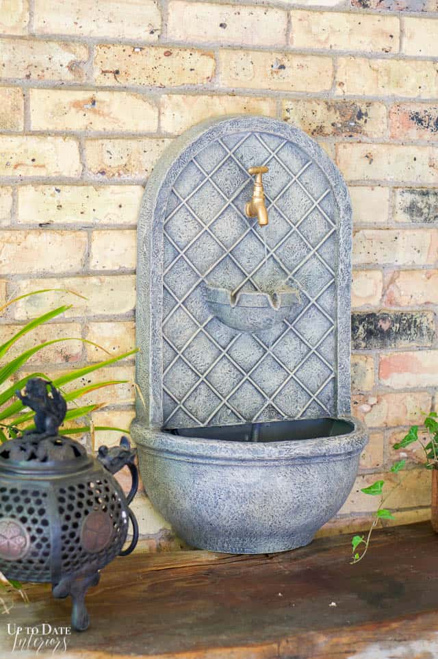 Outdoor fountain against brick wall on a table