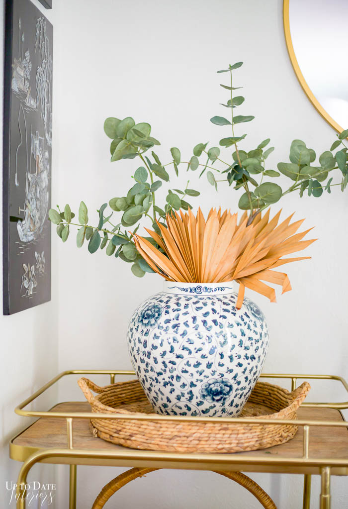 Eclectic Home Tour For Fall blue and white vase with stems on top of bar cart